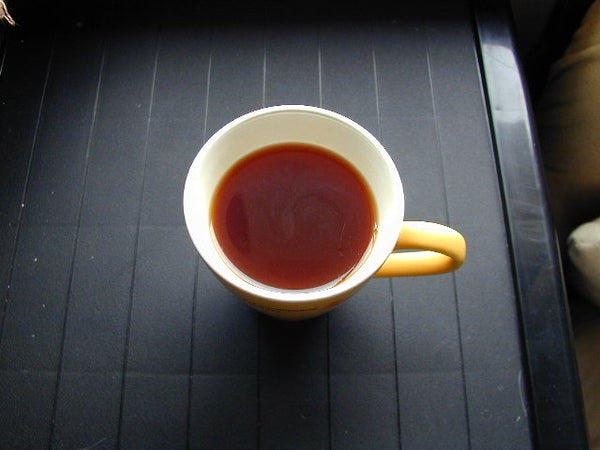 Cup of amber oxidized tea illustrating Korean balhyocha